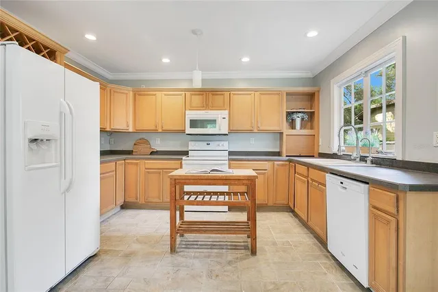 a kitchen with stainless steel appliances granite countertop a refrigerator sink and cabinets