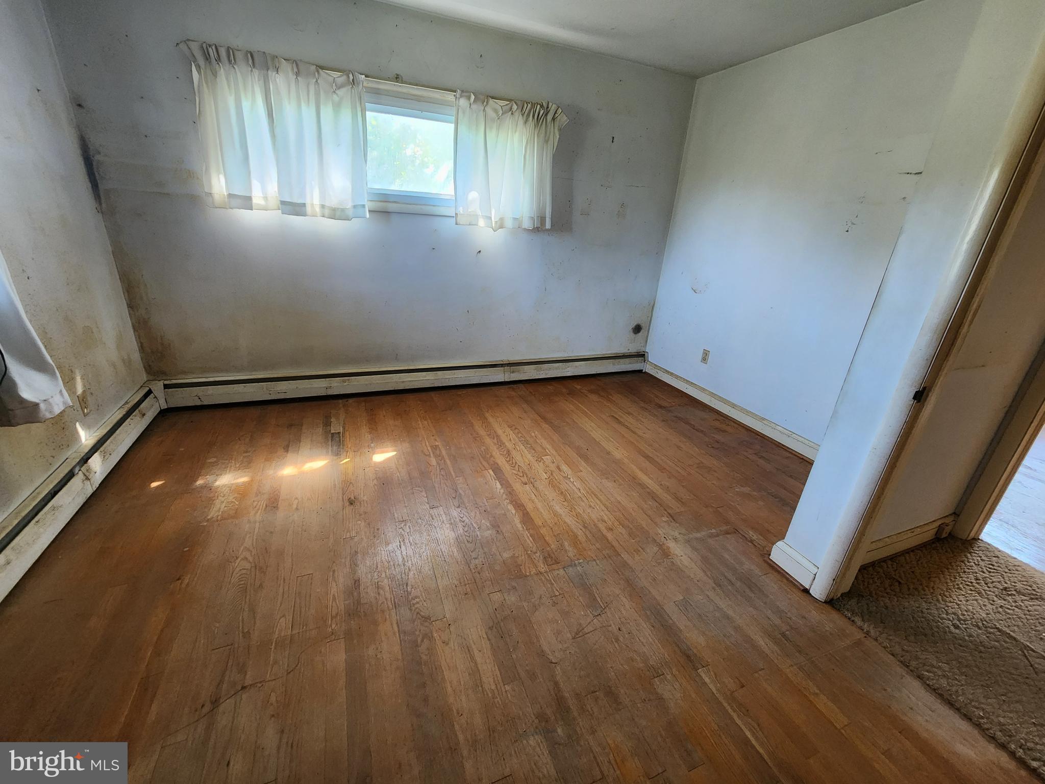 404 West Pearl Street Rising Sun, MD 21911 - Photo 3 of 7 an empty room with wooden floor and windows
