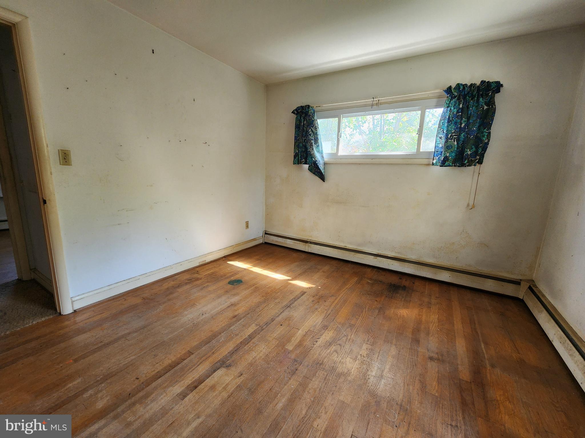 404 West Pearl Street Rising Sun, MD 21911 - Photo 6 of 7 an empty room with wooden floor and windows