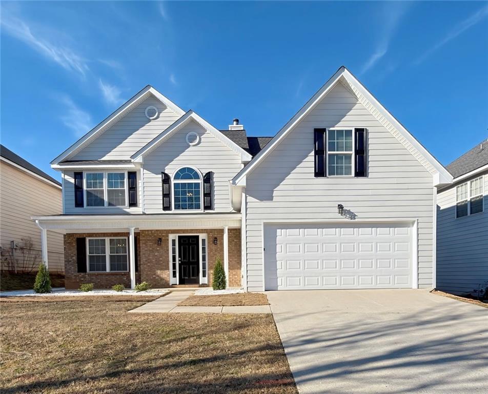 2770 Austin Ridge Drive Northeast Dacula, GA 30019 - Photo 1 of 51 a front view of a house with a yard
