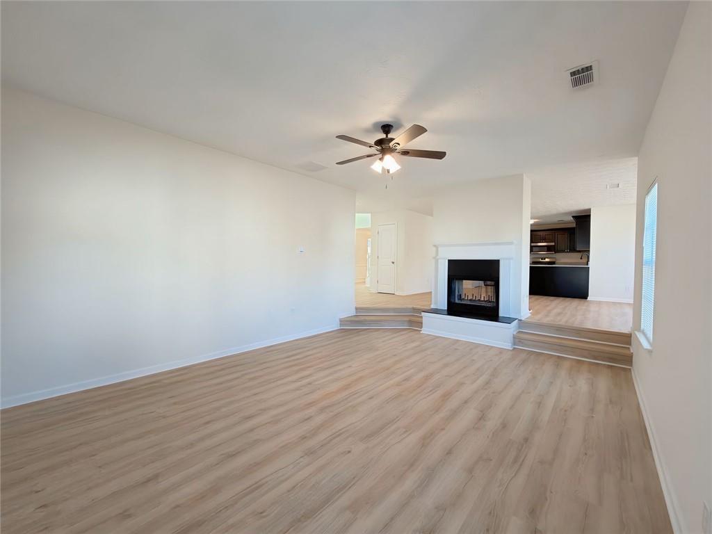 2770 Austin Ridge Drive Northeast Dacula, GA 30019 - Photo 11 of 51 a view of an empty room with a fireplace and a window