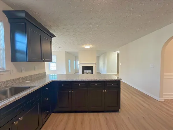 a kitchen with a sink and wooden cabinets