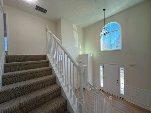 a view of entryway and hall with wooden floor