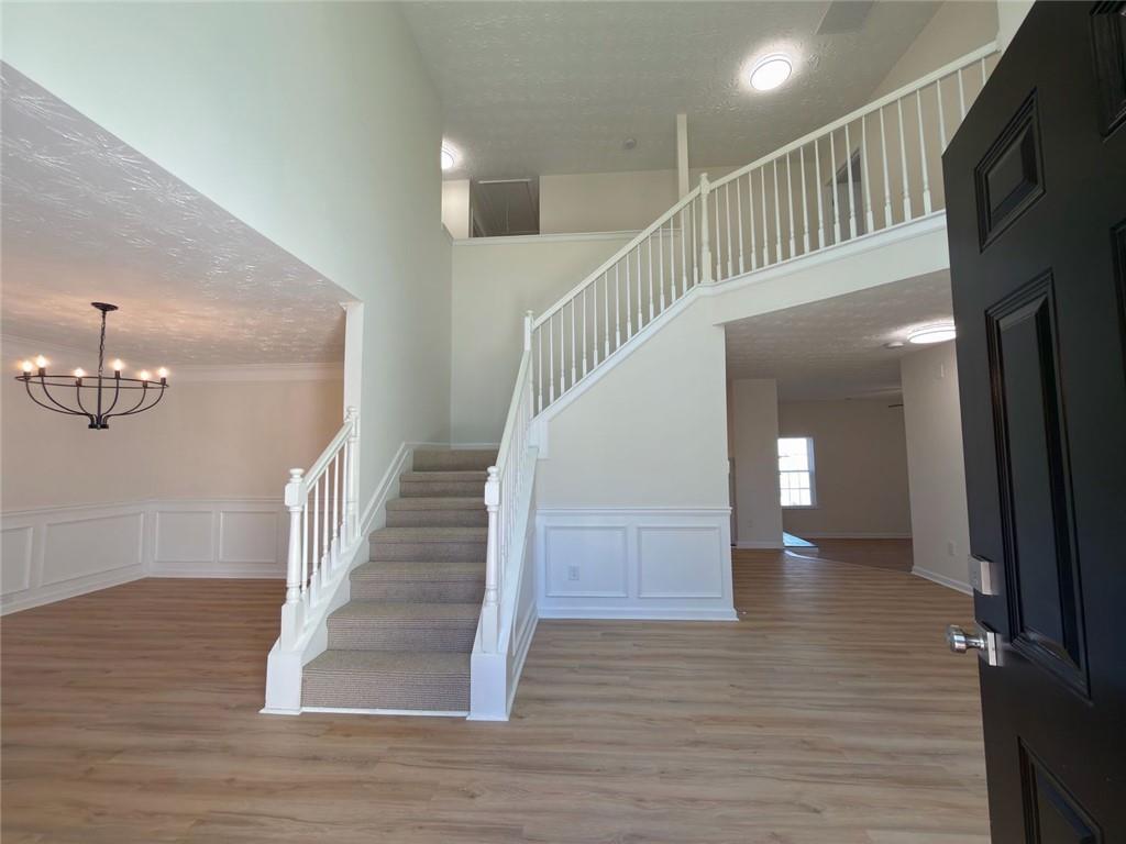 2770 Austin Ridge Drive Northeast Dacula, GA 30019 - Photo 3 of 51 a view of staircase with white walls and wooden floor