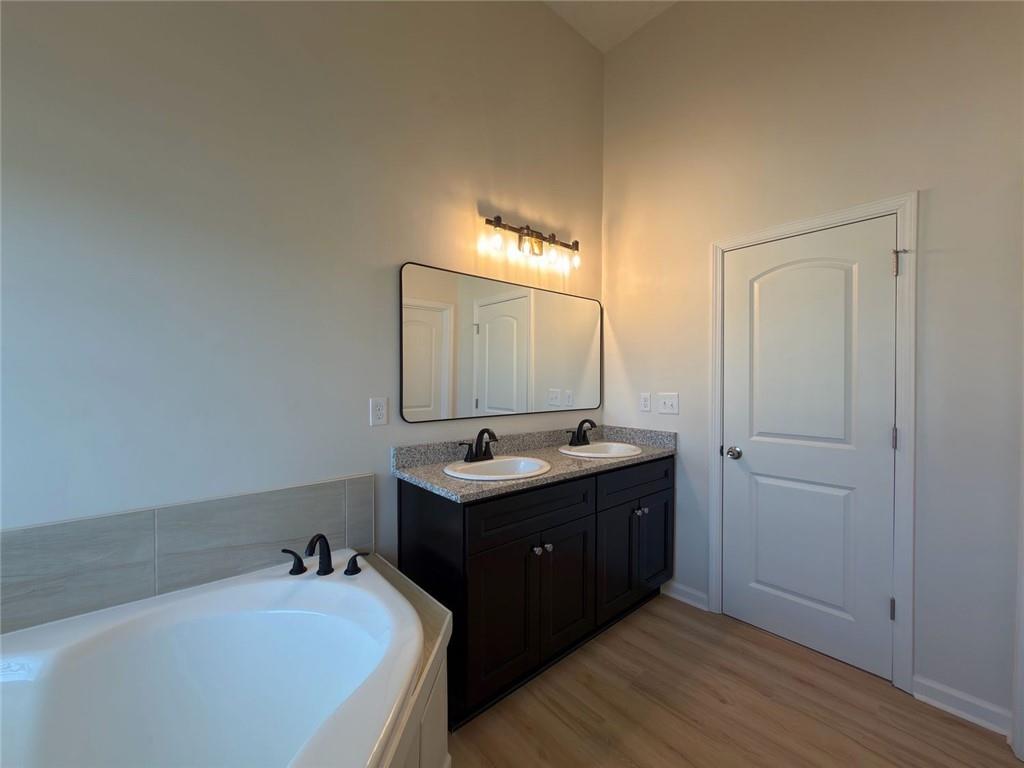2770 Austin Ridge Drive Northeast Dacula, GA 30019 - Photo 40 of 51 a bathroom with a tub sink and mirror