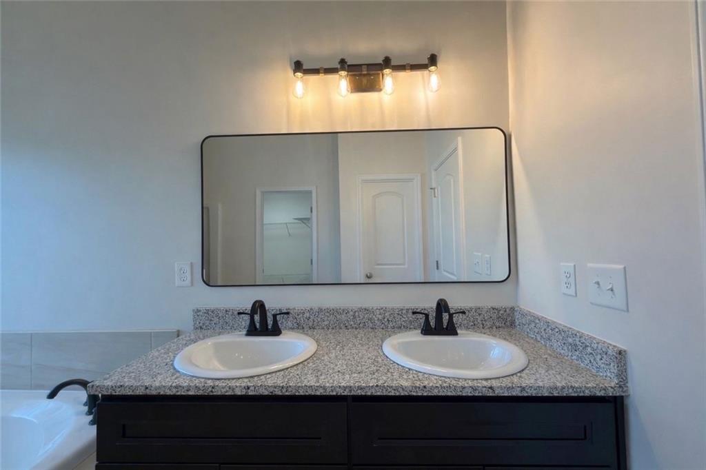 2770 Austin Ridge Drive Northeast Dacula, GA 30019 - Photo 41 of 51 a bathroom with double sink and a mirror
