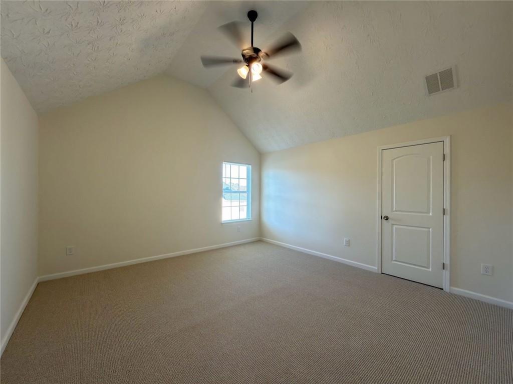 2770 Austin Ridge Drive Northeast Dacula, GA 30019 - Photo 43 of 51 an empty room with a chandelier fan and windows
