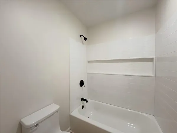 a bathroom with a bathtub and toilet