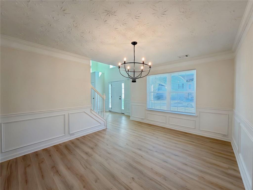 2770 Austin Ridge Drive Northeast Dacula, GA 30019 - Photo 7 of 51 a view of a room with wooden floor staircase and a kitchen space