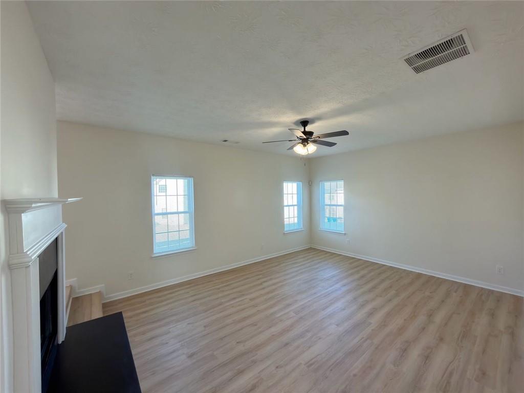 2770 Austin Ridge Drive Northeast Dacula, GA 30019 - Photo 8 of 51 a view of an empty room with a window and wooden floor