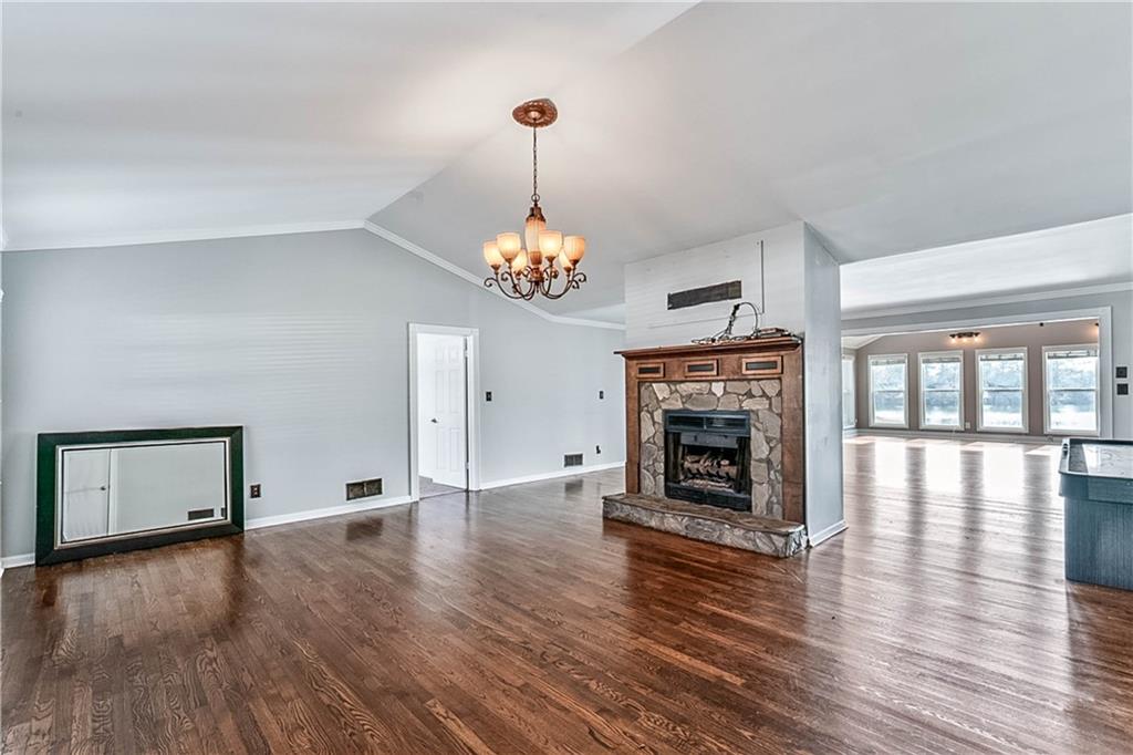 2670 Old Jackson Road Locust Grove, GA 30248 - Photo 11 of 30 a view of an empty room with wooden floor fireplace and a window