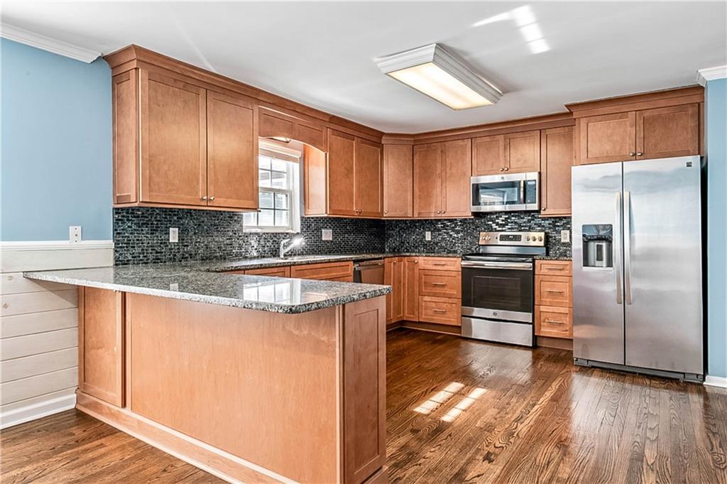2670 Old Jackson Road Locust Grove, GA 30248 - Photo 20 of 30 a kitchen with stainless steel appliances granite countertop a stove a sink and a refrigerator