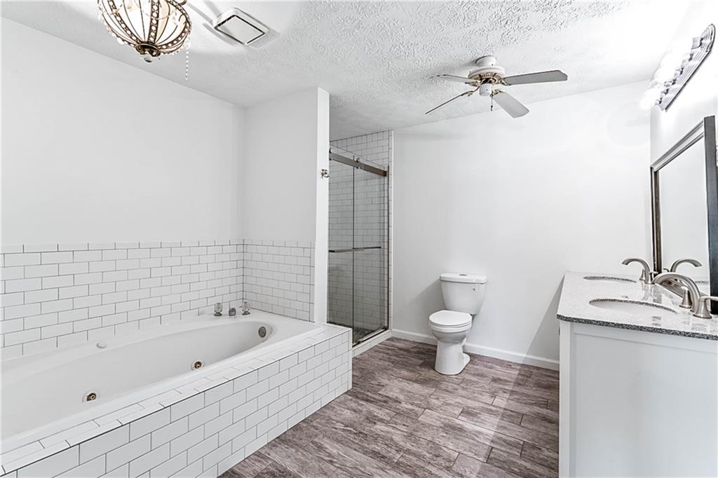 2670 Old Jackson Road Locust Grove, GA 30248 - Photo 24 of 30 a bathroom with a bathtub and a toilet
