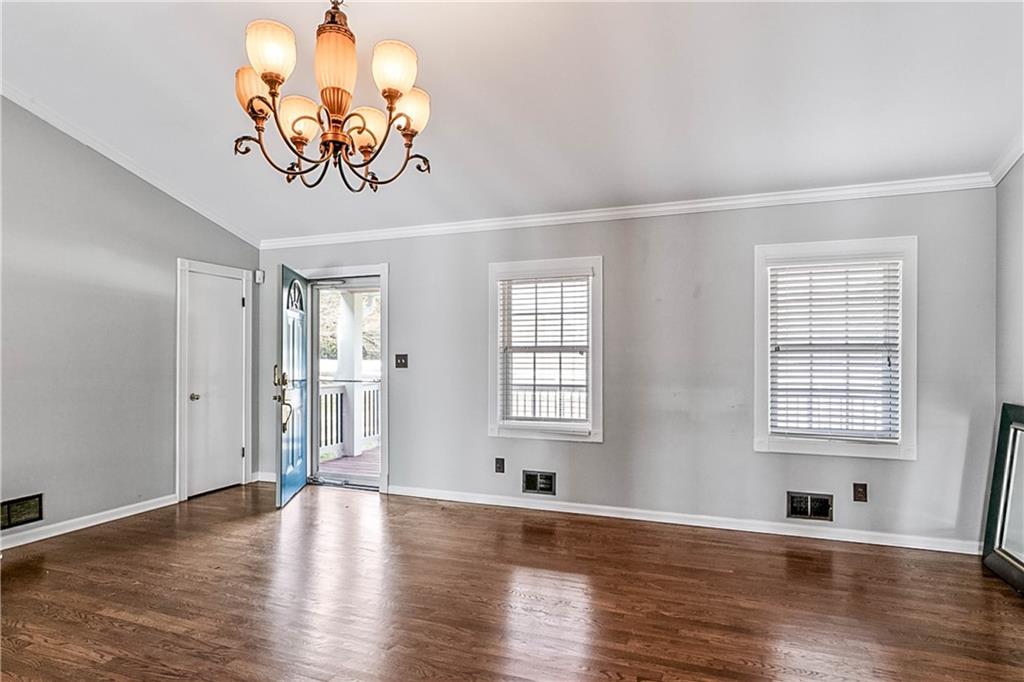 2670 Old Jackson Road Locust Grove, GA 30248 - Photo 9 of 30 an empty room with wooden floor and windows