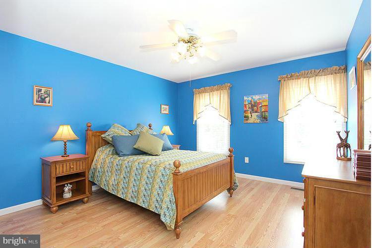 1840 Middlebridge Drive Silver Spring, MD 20906 - Photo 11 of 25 a bedroom with a bed and a chandelier