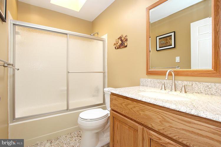 1840 Middlebridge Drive Silver Spring, MD 20906 - Photo 14 of 25 a bathroom with a granite countertop sink toilet and shower