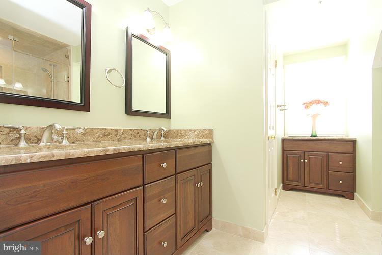 1840 Middlebridge Drive Silver Spring, MD 20906 - Photo 20 of 25 a bathroom with a granite countertop sink and a mirror