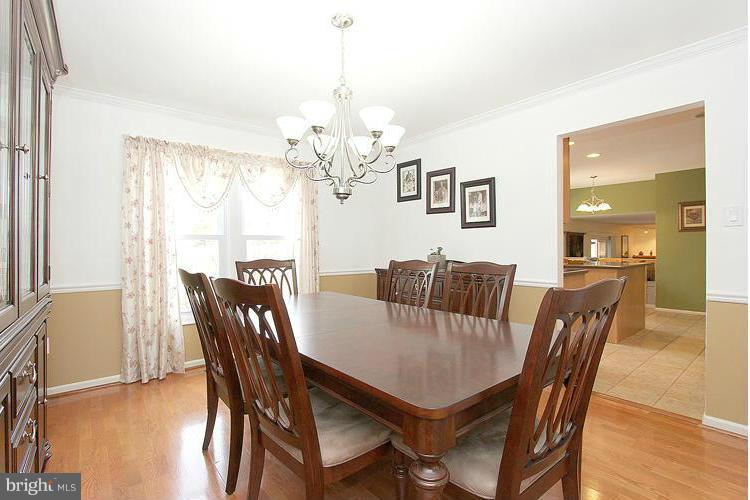 1840 Middlebridge Drive Silver Spring, MD 20906 - Photo 3 of 25 a view of a dining room with furniture a chandelier and wooden floor