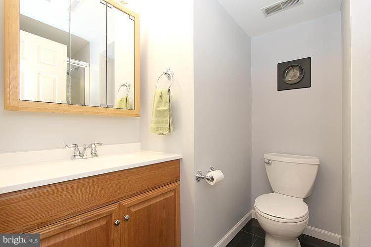 1840 Middlebridge Drive Silver Spring, MD 20906 - Photo 22 of 25 a bathroom with a toilet sink and mirror