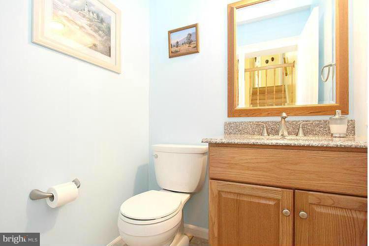 1840 Middlebridge Drive Silver Spring, MD 20906 - Photo 4 of 25 a bathroom with a granite countertop toilet sink and mirror