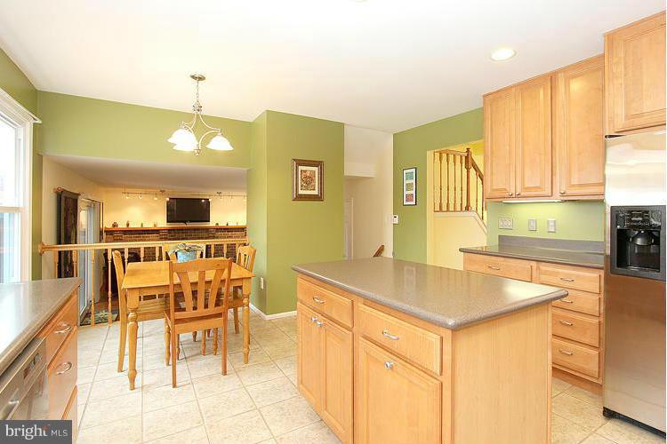 1840 Middlebridge Drive Silver Spring, MD 20906 - Photo 5 of 25 a kitchen with a table chairs and a refrigerator