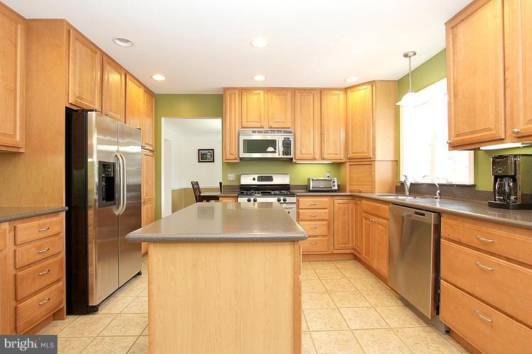 1840 Middlebridge Drive Silver Spring, MD 20906 - Photo 7 of 25 a kitchen with stainless steel appliances granite countertop a refrigerator a stove and a sink