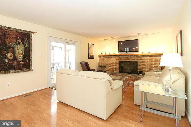 1840 Middlebridge Drive Silver Spring, MD 20906 - Photo 8 of 25 a living room with furniture a fireplace and a flat screen tv