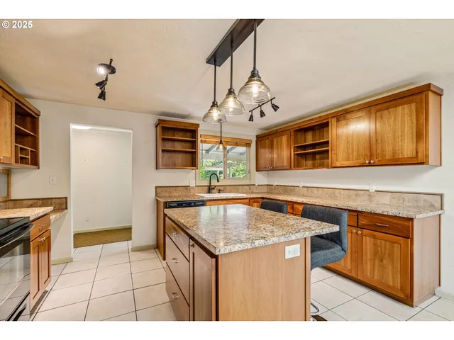 a kitchen with stainless steel appliances granite countertop a sink and cabinets