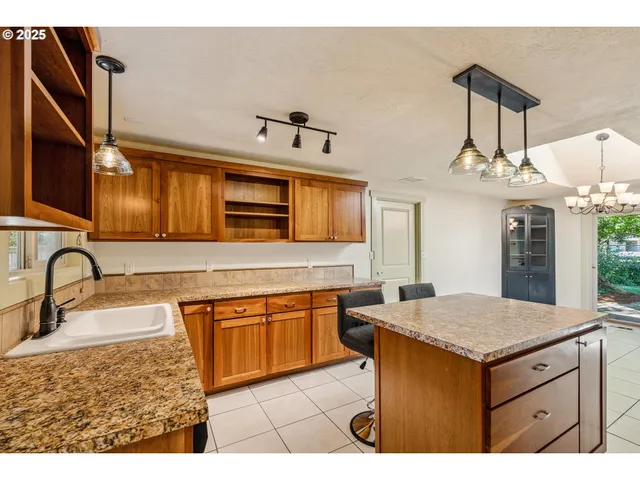 a spacious bathroom with a granite countertop sink a mirror and a bathtub