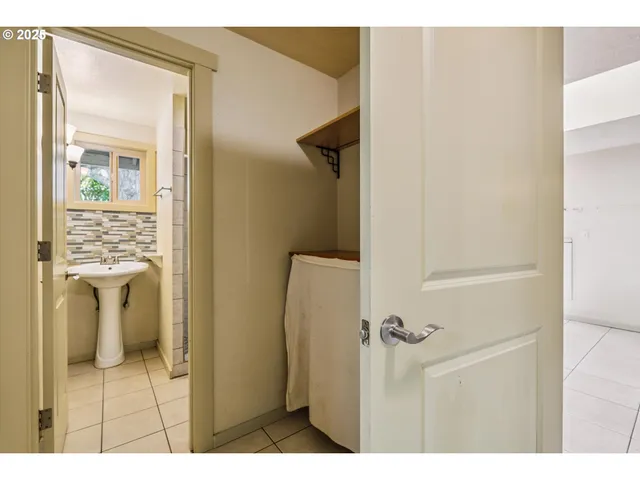 a bathroom with a sink shower and a mirror
