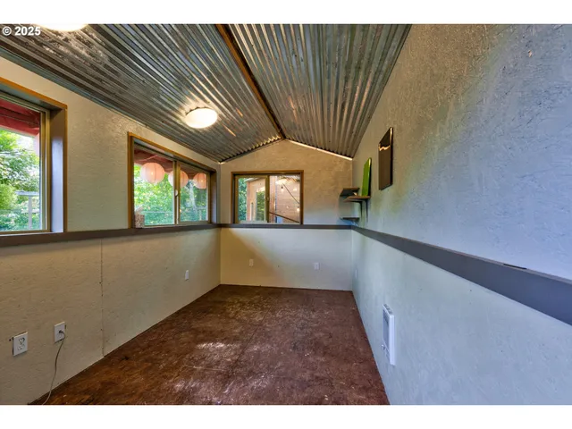 a view of a house with a yard and potted plants