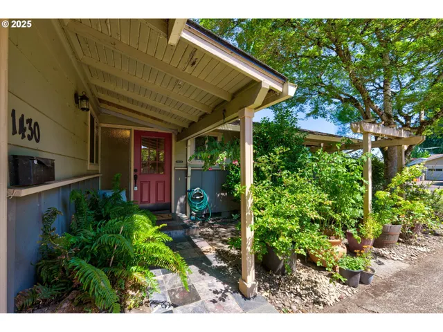 a view of a patio with table and chairs under an umbrella