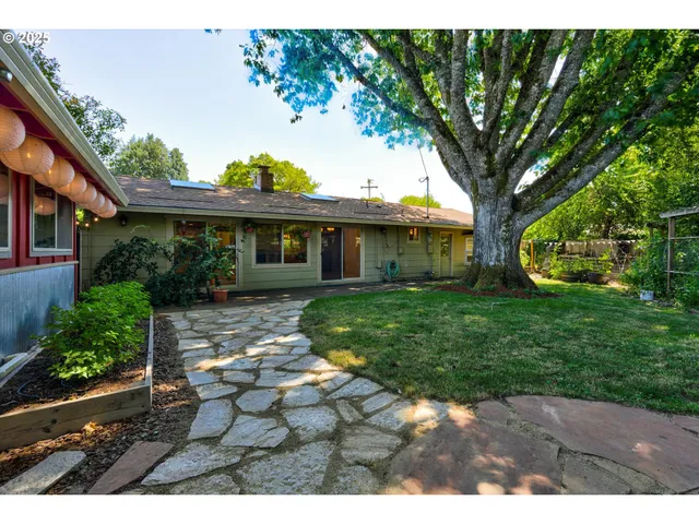 a view of a house with a backyard and a patio