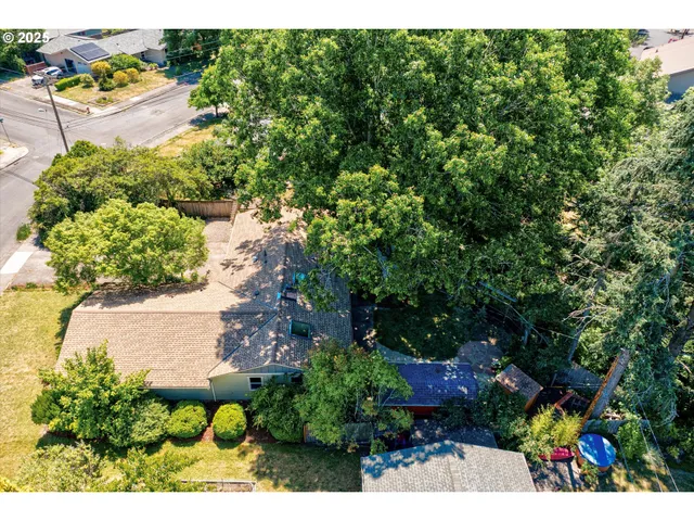 an aerial view of a house with a garden and swimming pool