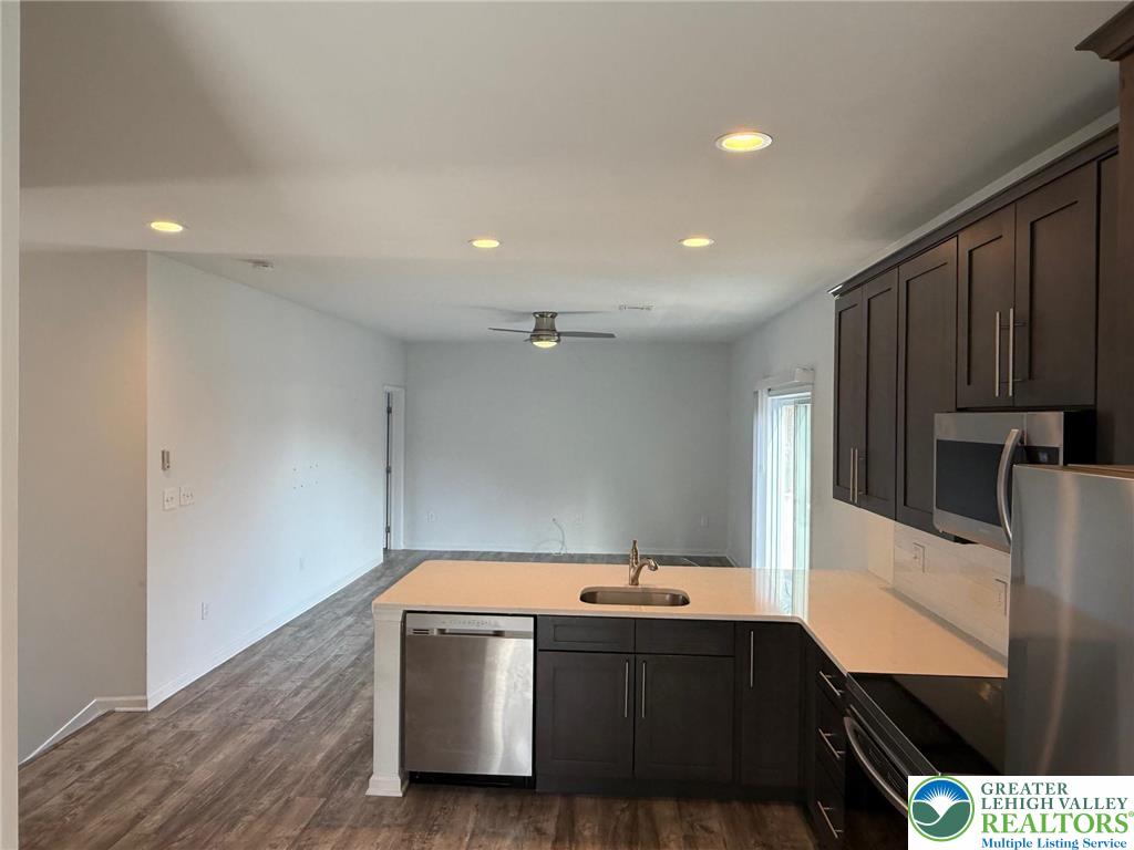 1332 Genoa Street, Unit 2 Bethlehem, PA 18018 - Photo 5 of 12 a view of a refrigerator a sink and wooden floor