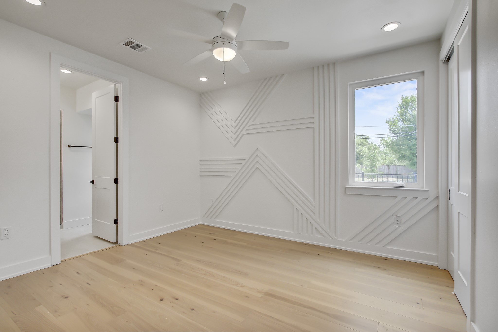 4127 East 12th Street, Unit 8 Austin, TX 78721 - Photo 17 of 32 Empty room with light wood-type flooring, a ceiling fan, recessed lighting, and baseboards