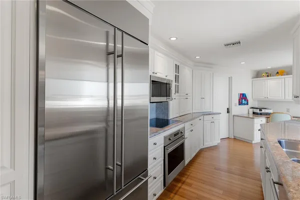 a kitchen with cabinets and stainless steel appliances