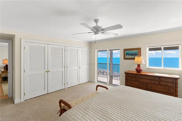 a spacious bedroom with a bed and a dresser