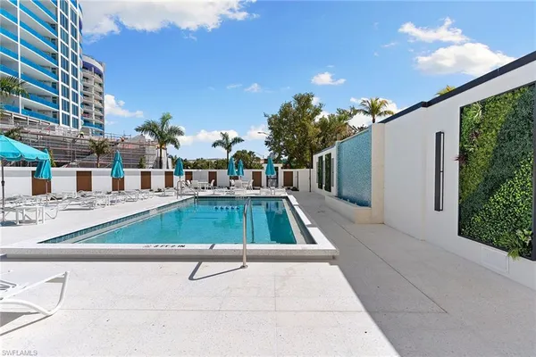 a swimming pool with outdoor seating and yard