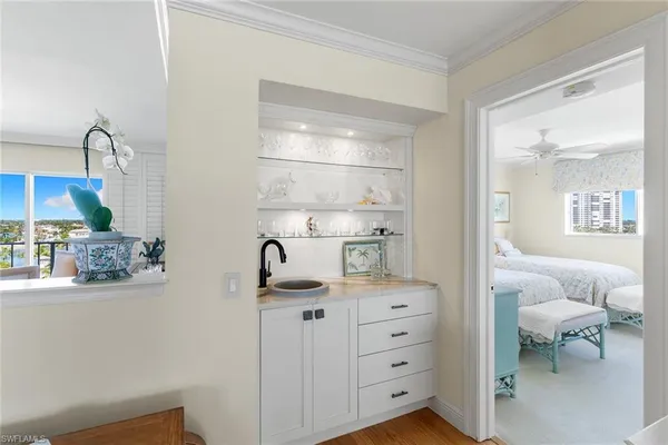 a room with a baby crib and a dresser