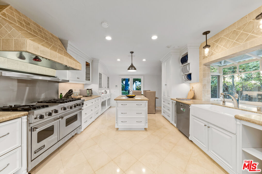 31202 Broad Beach Road Malibu, CA 90265 - Photo 12 of 38 a large white kitchen with stainless steel appliances
