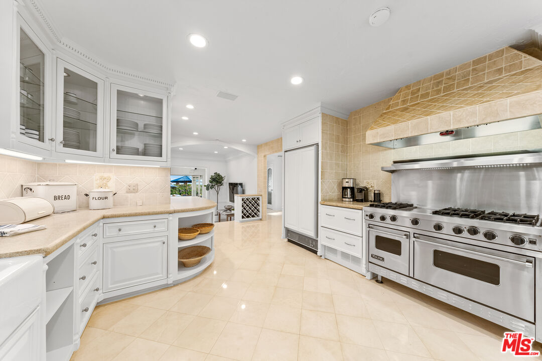 31202 Broad Beach Road Malibu, CA 90265 - Photo 13 of 38 a kitchen with white cabinets and appliances