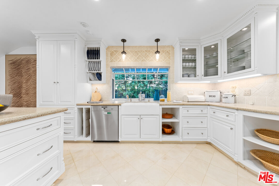 31202 Broad Beach Road Malibu, CA 90265 - Photo 14 of 38 a kitchen with granite countertop white cabinets and white appliances