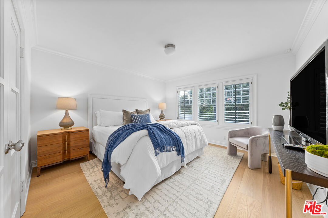 31202 Broad Beach Road Malibu, CA 90265 - Photo 21 of 38 a bedroom with a bed and a flat tv screen on dresser