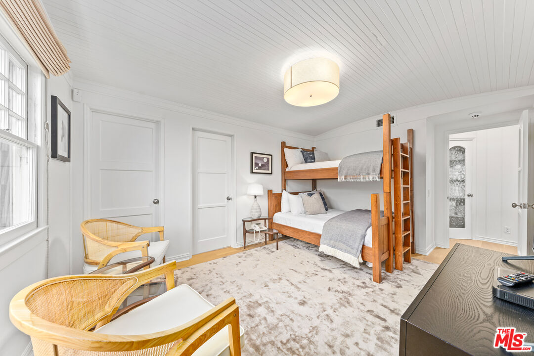 31202 Broad Beach Road Malibu, CA 90265 - Photo 23 of 38 a bedroom with a bed and wooden floor