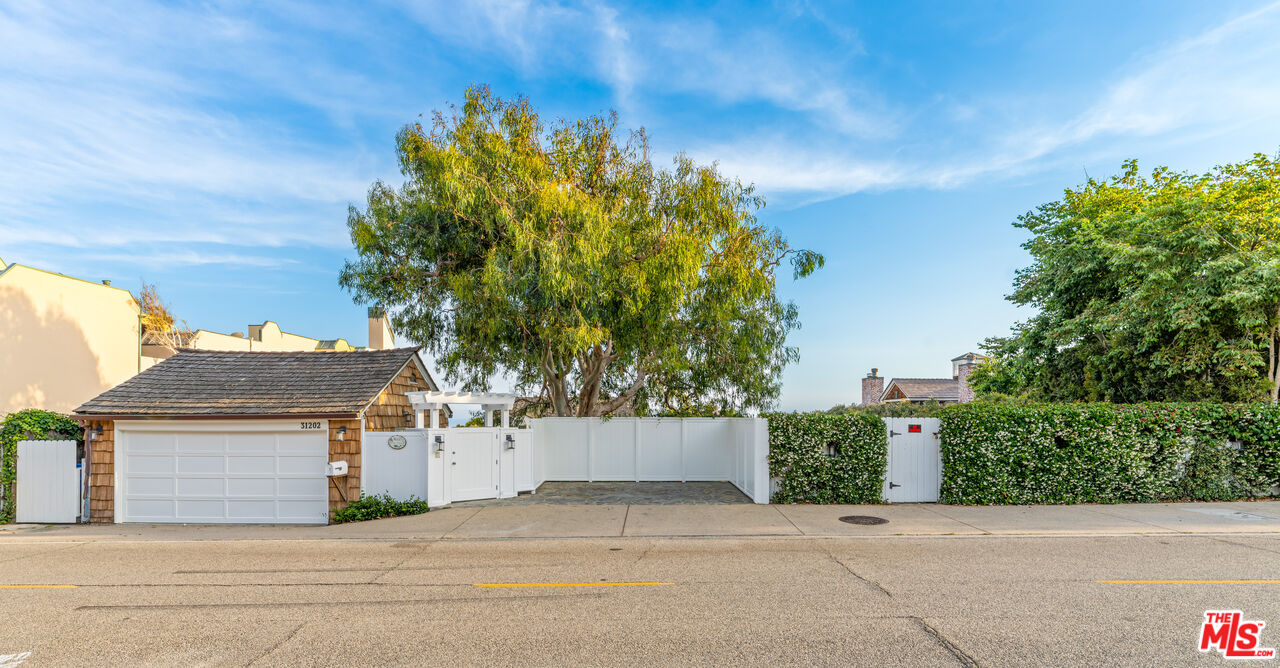 31202 Broad Beach Road Malibu, CA 90265 - Photo 5 of 38 a front view of a house with a yard and garage