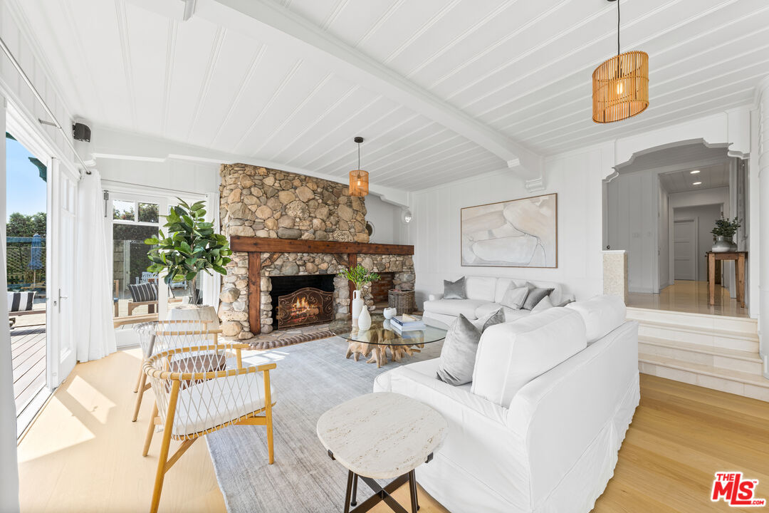 31202 Broad Beach Road Malibu, CA 90265 - Photo 7 of 38 a living room with furniture a fireplace and a flat screen tv