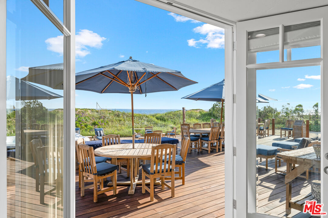 31202 Broad Beach Road Malibu, CA 90265 - Photo 8 of 38 a view of a dining room with furniture wooden floor and chandelier