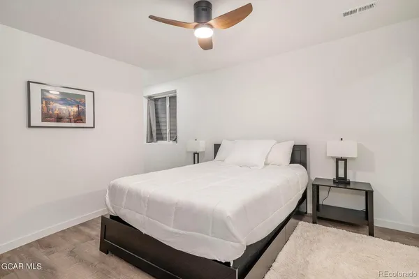 a bedroom with a bed and lamps