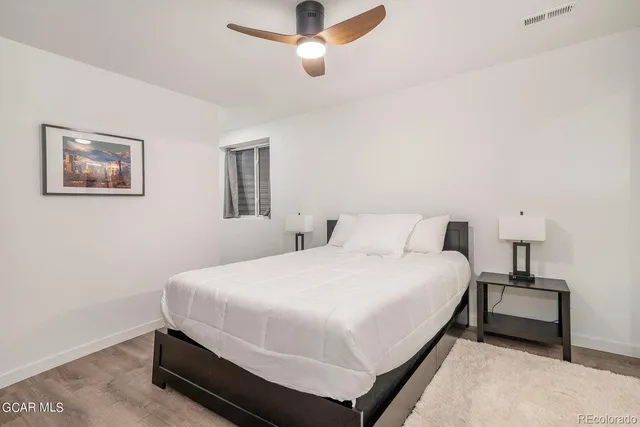 a bedroom with a bed and lamps